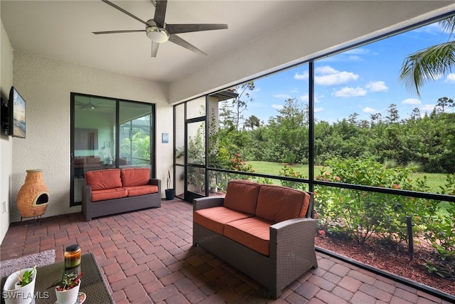 sunroom featuring ceiling fan