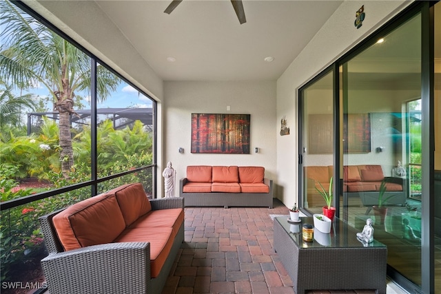 sunroom / solarium featuring ceiling fan