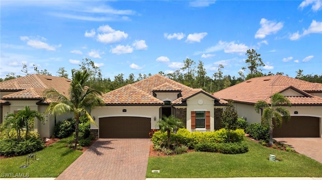 mediterranean / spanish-style house with a garage and a front yard