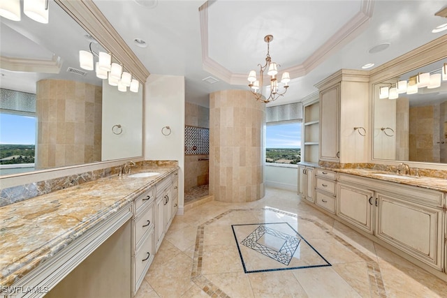 full bathroom featuring ornamental molding, two vanities, a tray ceiling, and a sink