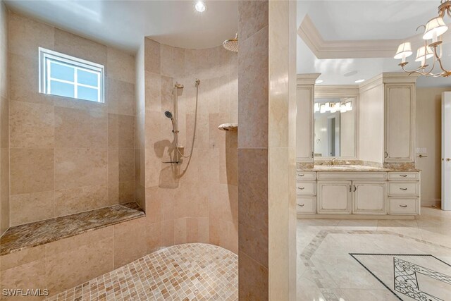 bathroom featuring crown molding, vanity, an inviting chandelier, and walk in shower