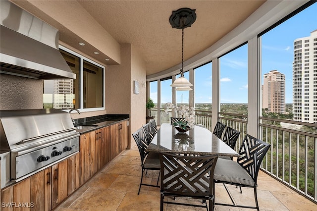 sunroom with a view of city and a sink