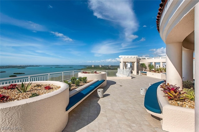 view of patio / terrace featuring a water view and a pergola