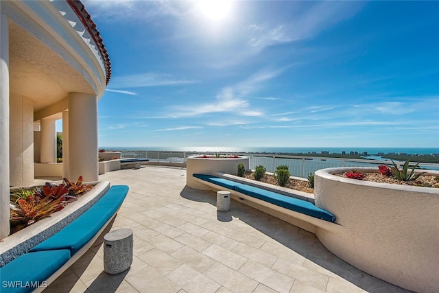 view of patio with a water view