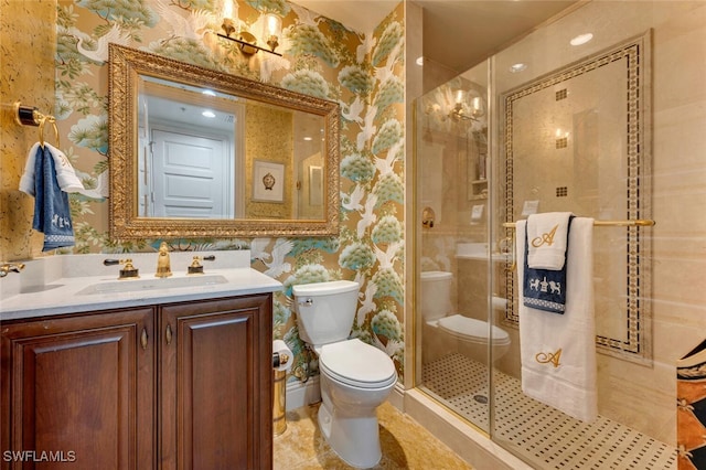 full bath with toilet, a stall shower, vanity, and wallpapered walls