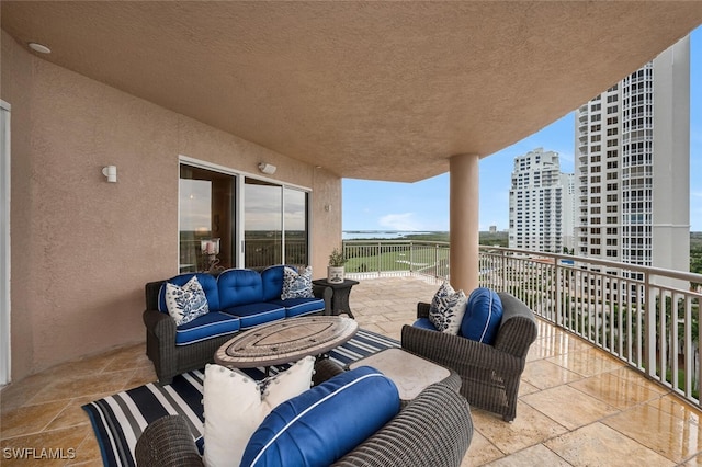 view of patio featuring a balcony, a city view, and outdoor lounge area