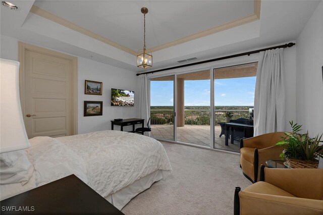 carpeted bedroom featuring access to exterior, a raised ceiling, visible vents, and crown molding