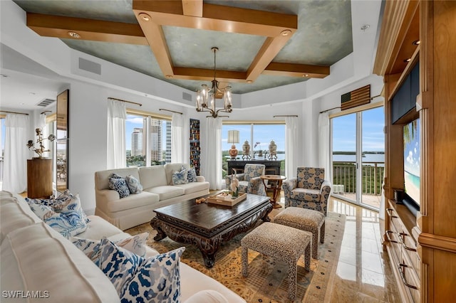 living room featuring beamed ceiling, plenty of natural light, visible vents, and a notable chandelier