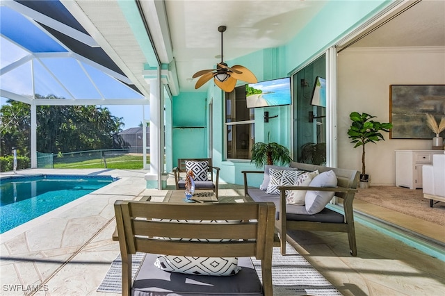 view of swimming pool with ceiling fan, a patio area, a lanai, and an outdoor hangout area