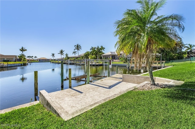 view of dock featuring a lawn and a water view