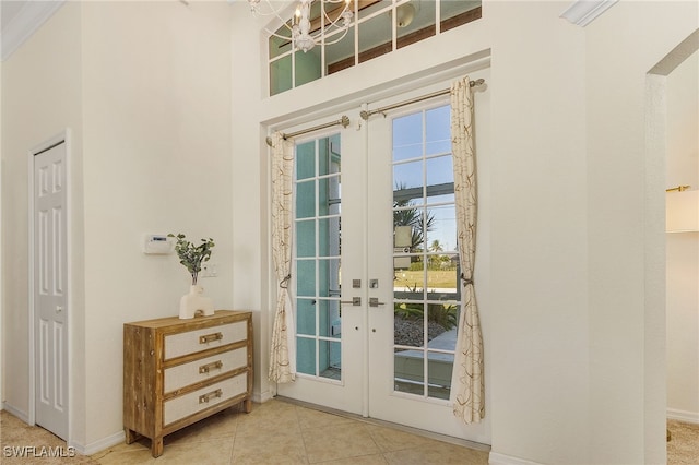 doorway to outside with light tile patterned flooring and french doors