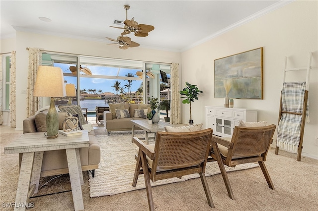 living room with light carpet, a water view, ceiling fan, and ornamental molding