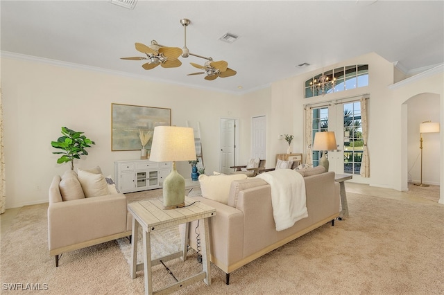 carpeted living room with crown molding and ceiling fan