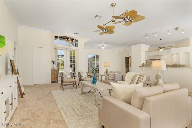 carpeted living room featuring ceiling fan, french doors, and crown molding