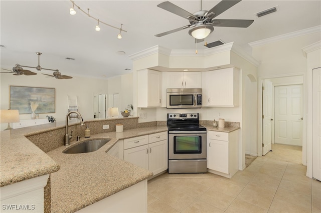 kitchen with white cabinets, stainless steel appliances, sink, kitchen peninsula, and ornamental molding