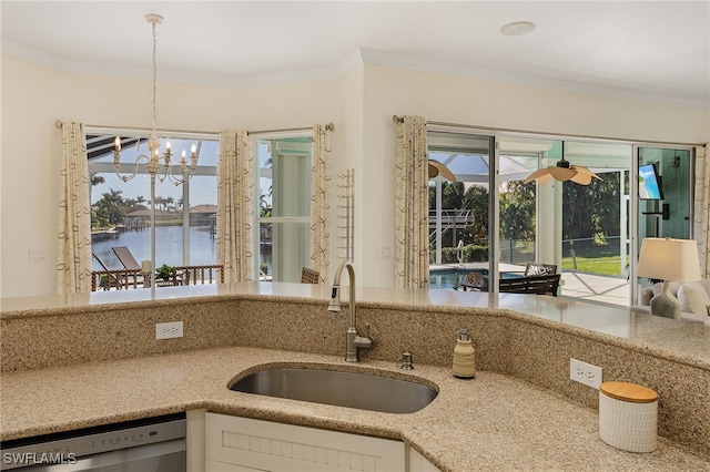 kitchen with dishwasher, sink, decorative light fixtures, a water view, and ornamental molding