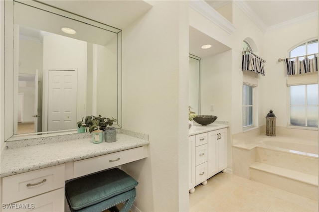 bathroom featuring vanity, a washtub, crown molding, and tile patterned floors