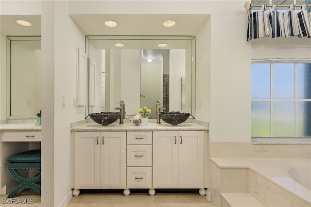 bathroom featuring vanity, a bath, and tile patterned flooring