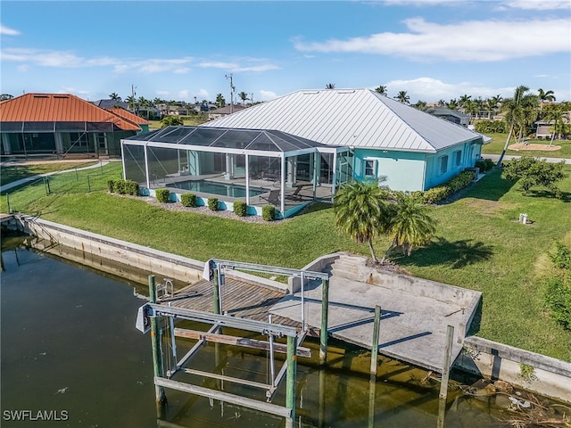 view of dock featuring a water view, glass enclosure, and a lawn