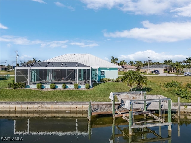 dock area featuring a water view, glass enclosure, and a lawn