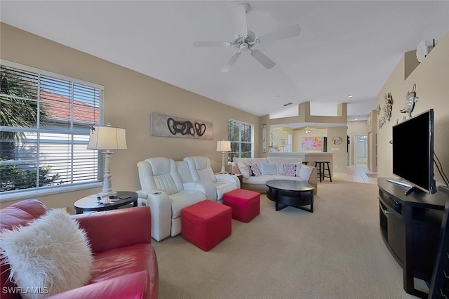 living room featuring lofted ceiling, light colored carpet, and ceiling fan