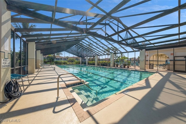 view of pool featuring a patio and glass enclosure