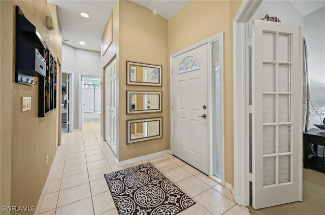 foyer entrance with light tile patterned floors