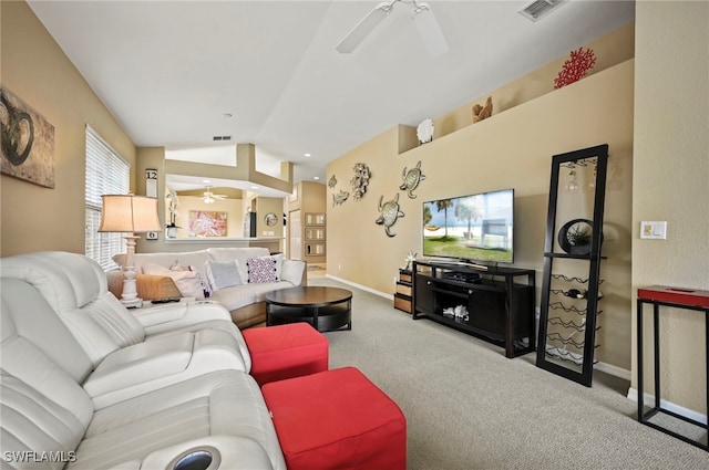 living room with ceiling fan, vaulted ceiling, and light carpet