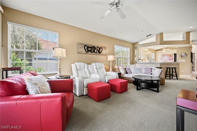 living room featuring light carpet, ceiling fan, vaulted ceiling, and a healthy amount of sunlight