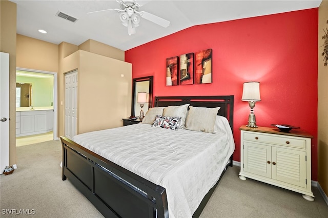 bedroom featuring lofted ceiling, ceiling fan, carpet, connected bathroom, and a closet