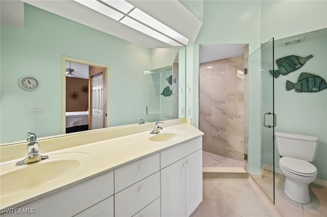 bathroom with tile patterned flooring, vanity, an enclosed shower, and toilet