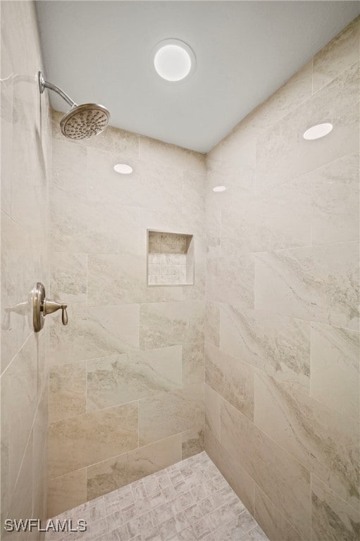 bathroom with tiled shower