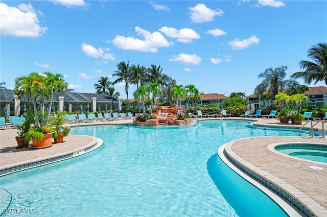 view of pool featuring a hot tub and a patio