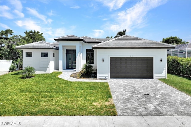 view of front of home featuring a garage and a front lawn