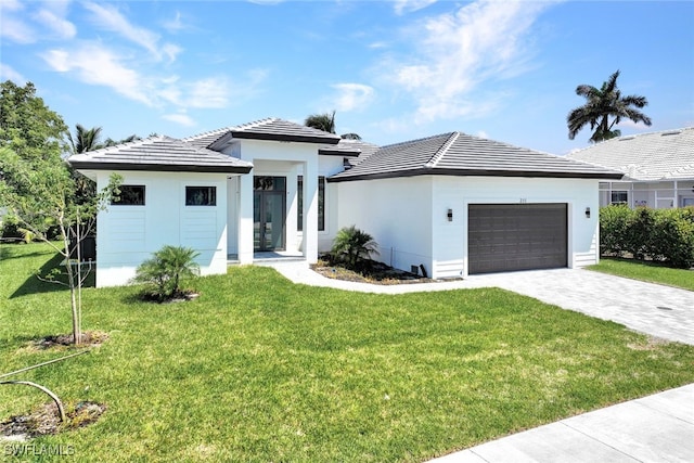 view of front of home with a garage and a front yard