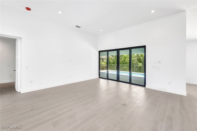 unfurnished room with light hardwood / wood-style floors