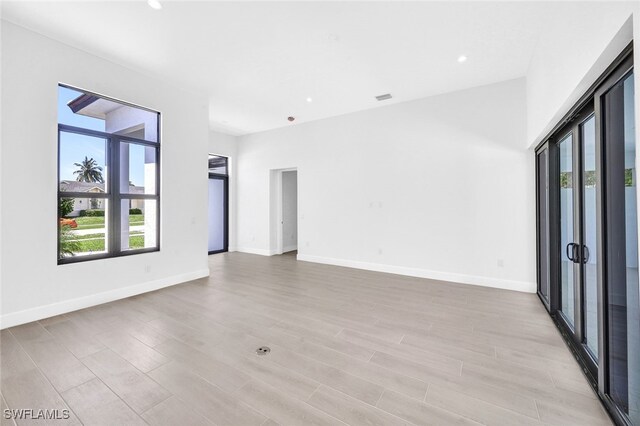 spare room with light wood-type flooring