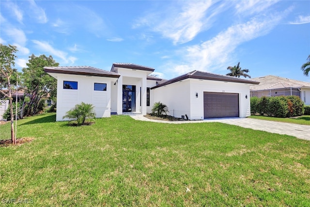 view of front of house with a garage and a front yard