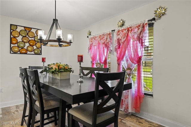 dining space featuring hardwood / wood-style flooring and a notable chandelier