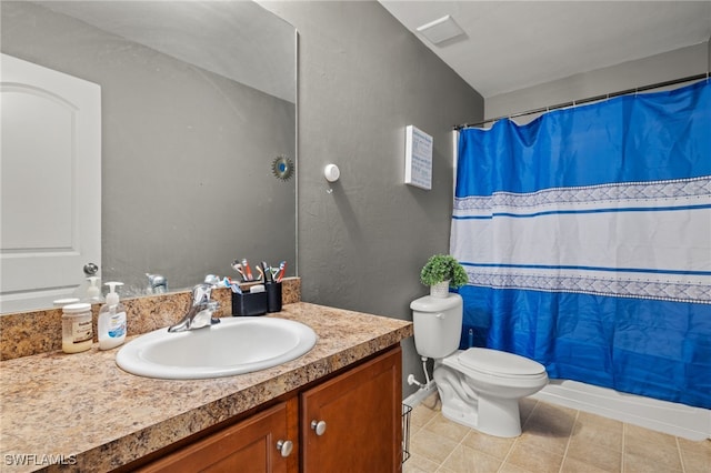 bathroom featuring tile patterned flooring, vanity, and toilet