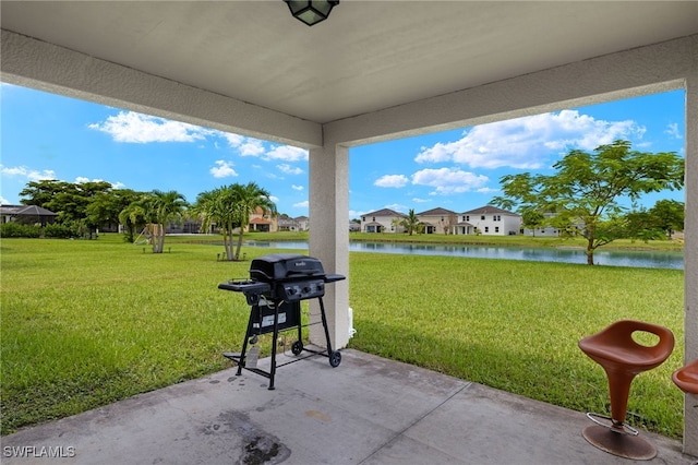 view of patio / terrace with a grill and a water view