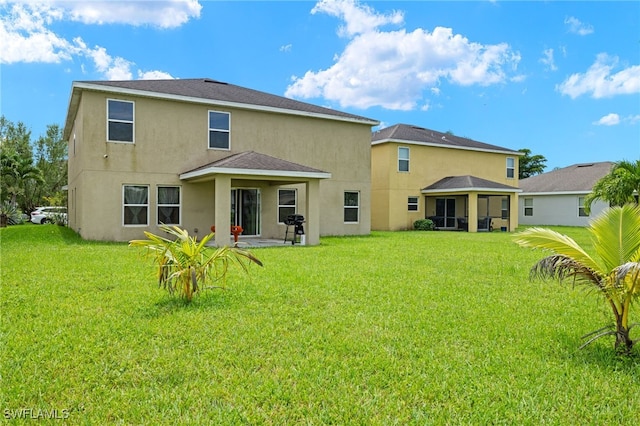 back of house featuring a yard