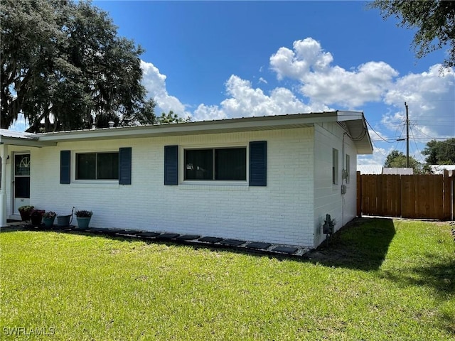 view of home's exterior with a yard