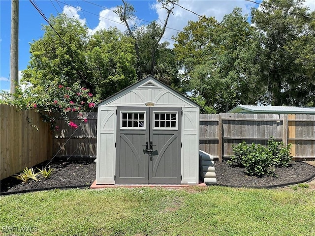 view of outbuilding with a lawn