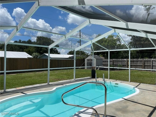 view of pool featuring a yard, a storage unit, and a patio