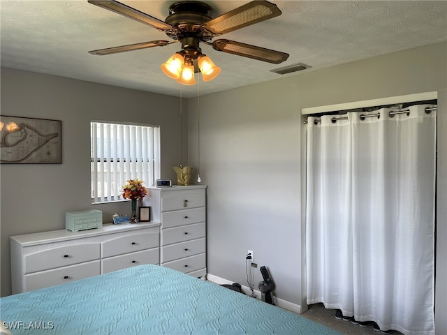 unfurnished bedroom featuring ceiling fan and a textured ceiling