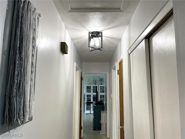 corridor with a textured ceiling