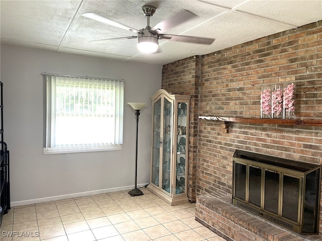 living room with a fireplace and ceiling fan