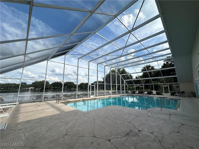 outdoor pool featuring a lanai and a patio area