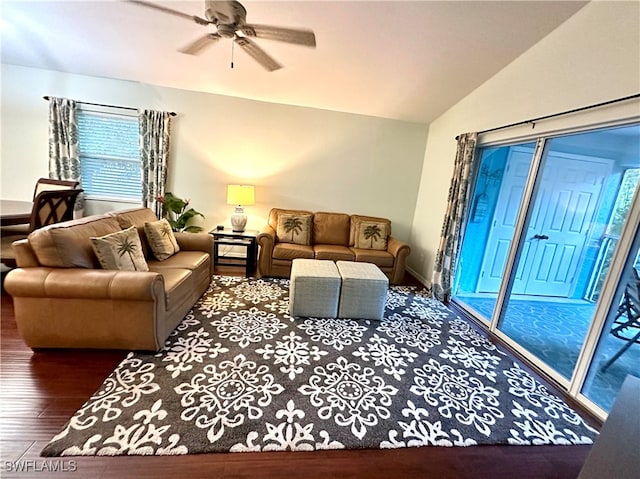 living room with ceiling fan, wood-type flooring, and lofted ceiling